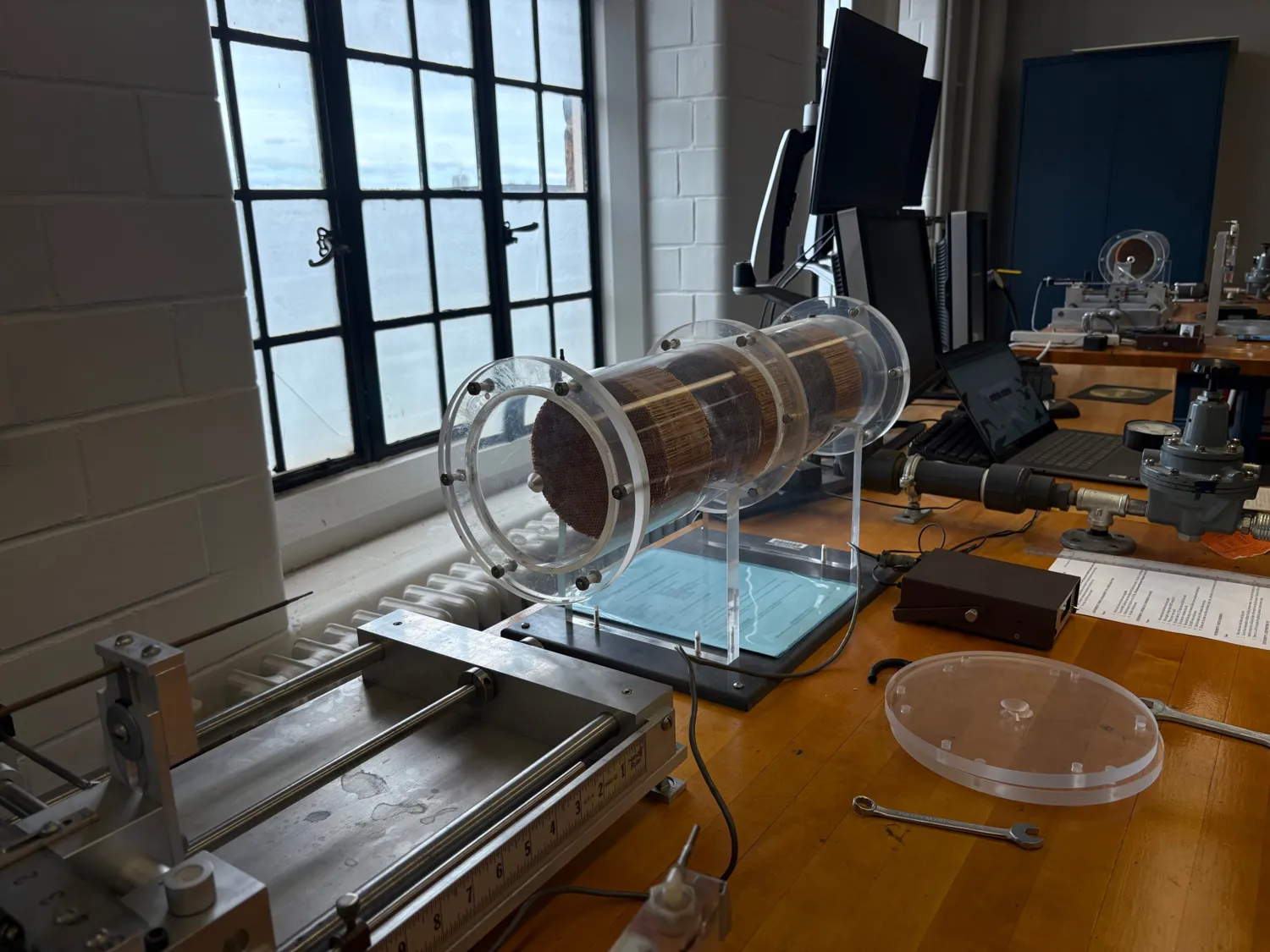 Acrylic plenum with honeycomb sections on a lab bench, traverse in the foreground